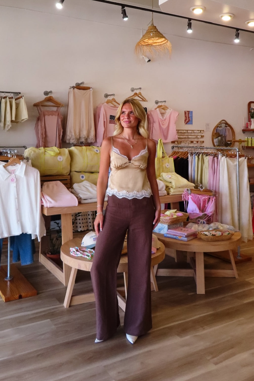 Brown, flowy linen pants with mid rise, zipper closure, wide leg, and natural textured fabric