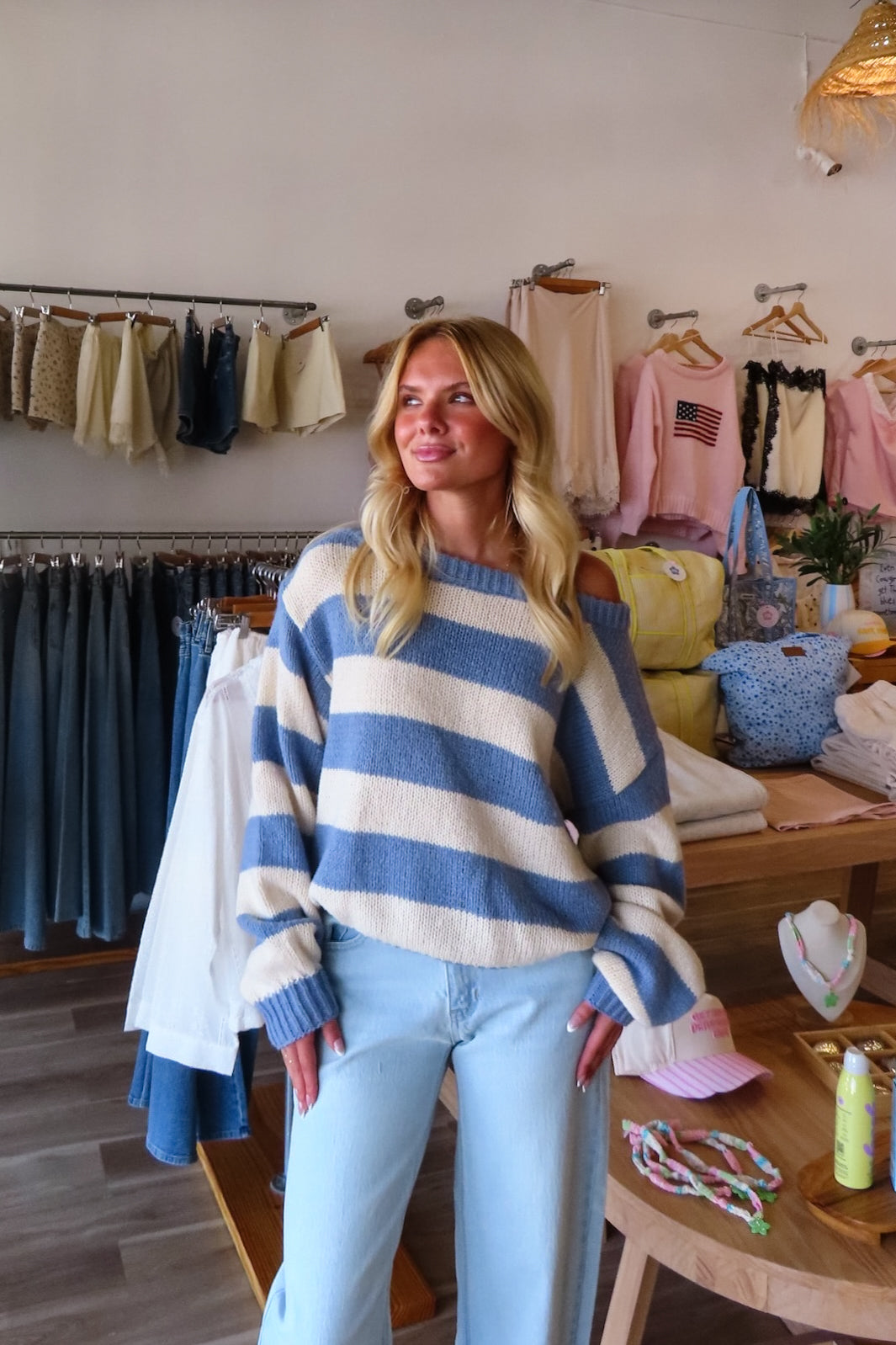 Blue, striped knit sweater with off-shoulder boat neckline and ribbed hem