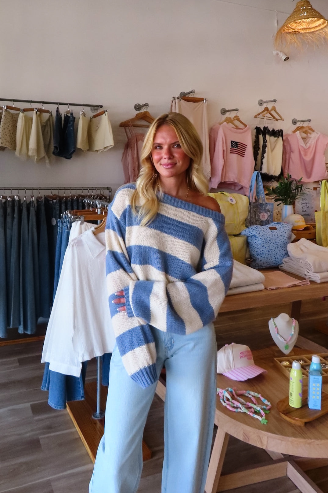 Blue, striped knit sweater with off-shoulder boat neckline and ribbed hem