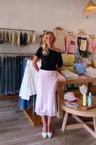 Pink, polka dot satin midi skirt with bias cut, lined interior lace hem, and side zipper