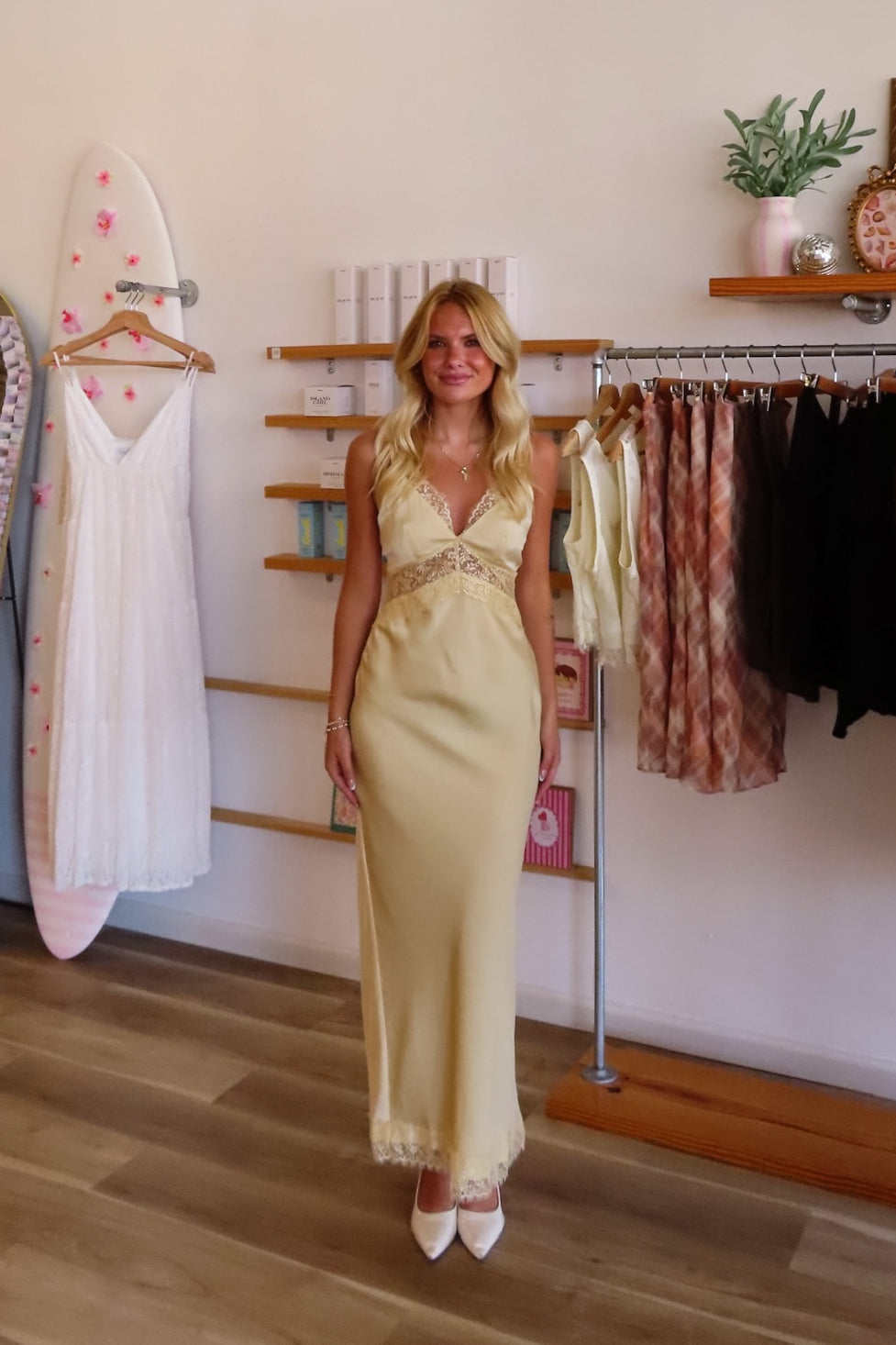 Yellow, satin maxi dress with V neckline, lace trim, open back, and adjustable cross straps