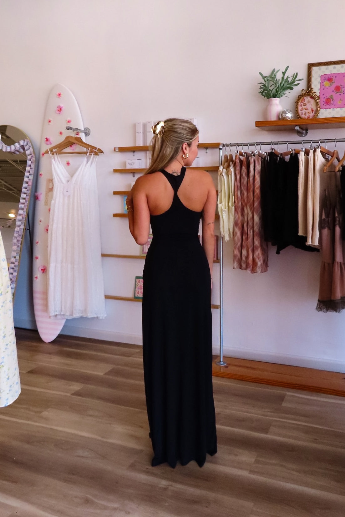 Black, maxi dress with halter neckline, front cutout, fitted bodice, and draped scarf fabric