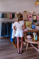 White, denim shorts with mid rise, straight fit, and finished hem