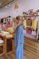 Blue, striped top with crew neckline, long sleeves, and drop shoulder