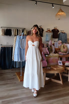 White, lined strapless maxi dress with twisted bust, center cutout, and double elasticated back straps