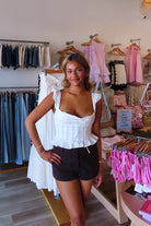 White, poplin tank top with square neckline, front tie, ruffled trim, adjustable straps, and front buttons
Virginia Beach Boutique, 757 Boutique, Online Shopping for Women, summer aesthetic, brunch outfit, vacation style, vacation outfits, beach boutique, beach fashion, beach outfits, women’s boutique clothing, boutique clothing for women, coastal cowgirl outfits, coastal aesthetic clothing, business casual, concert outfit, 2000s fashion, western outfits