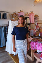 Blue, jersey top with asymmetric off shoulder neckline, ruched waist, and mid-length sleeves