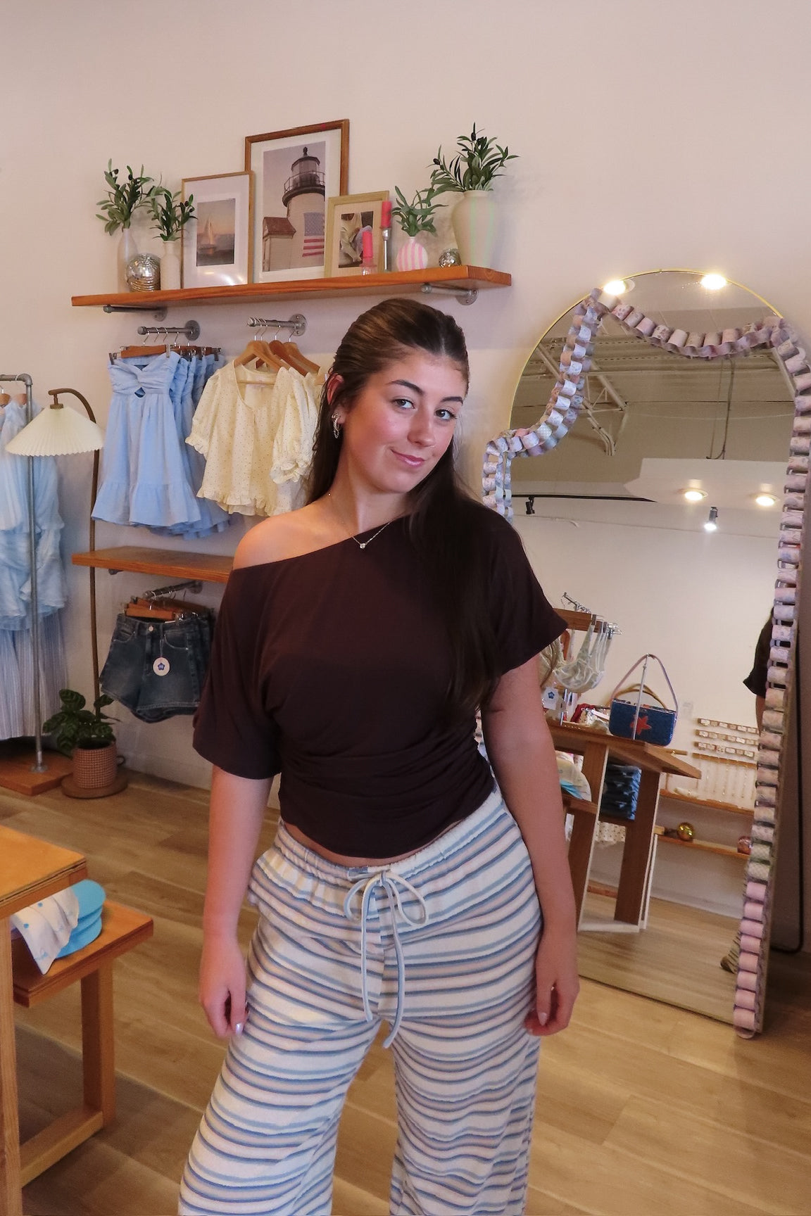 Brown, jersey top with asymmetric off shoulder neckline, ruched waist, and mid-length sleeves
