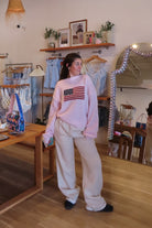 Cream, wide leg sweatpants with inner drawstring, side pockets, and fleece lining