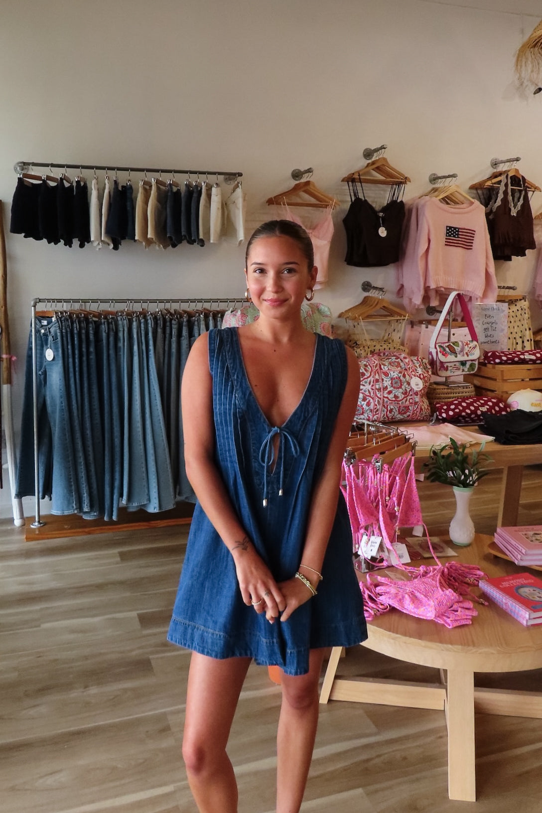 Blue, denim romper with V neckline, front tie, pockets, and pleated back, women’s boutique clothing, boutique clothing for women, coastal cowgirl outfits, coastal aesthetic clothing, business casual, concert outfit, 2000s fashion, western outfits