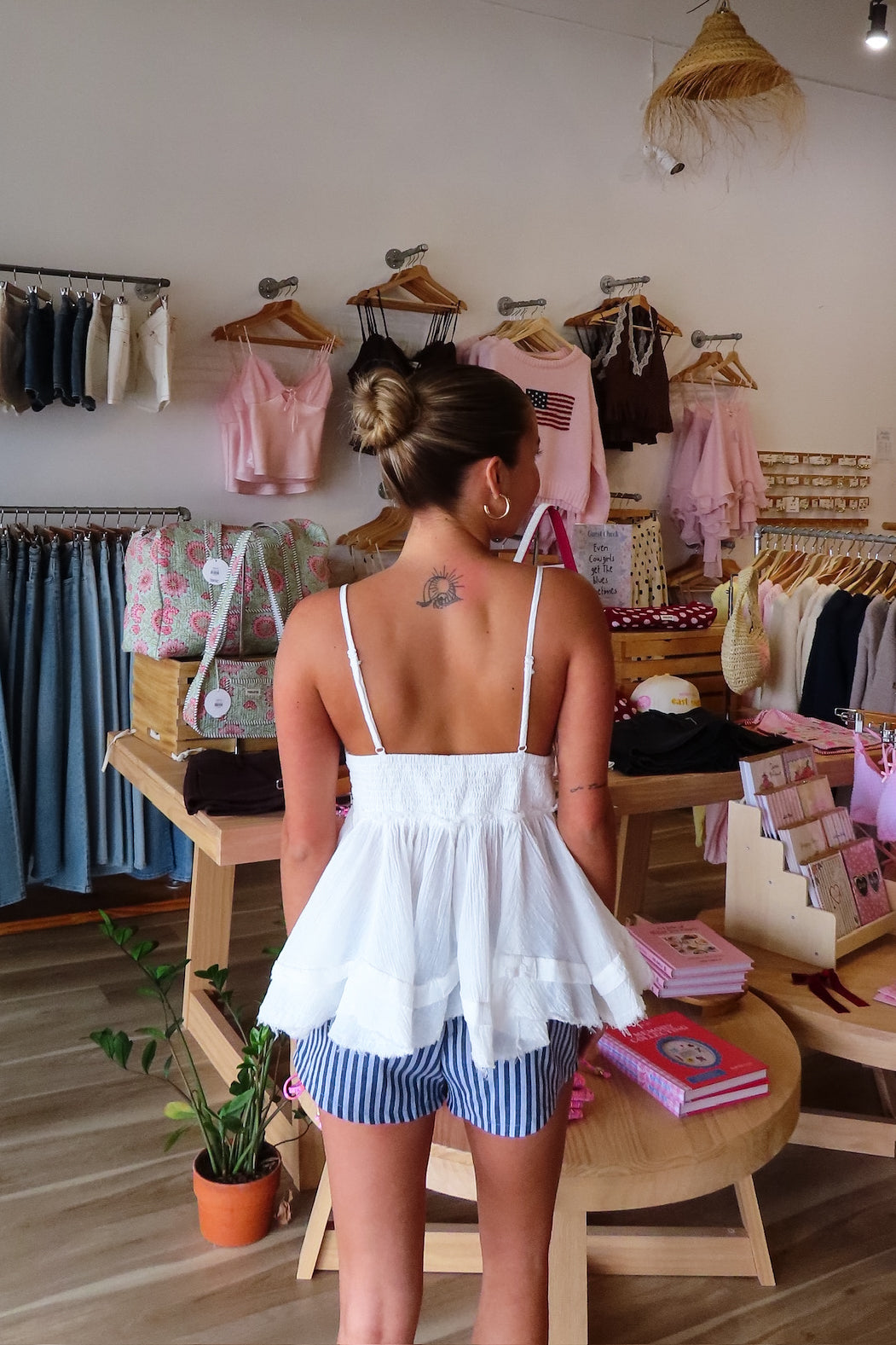 White, babydoll tiered top with V neckline, gathered bust, raw hem, crinkle gauze fabric, and adjustable Straps, beach boutique, beach fashion, beach outfits, women’s boutique clothing, boutique clothing for women, coastal cowgirl outfits, coastal aesthetic clothing