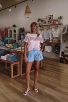 Blue, light denim shorts with high rise, bubble silhouette, and front pleats, vintage shorts, high rise denim shorts, pleated shorts, pleated, summer shorts, beach boutique, casual summer shorts, summer denim