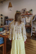 Yellow, floral blouse with lace trim and panelling, quarter sleeves, button down, and cropped length, boho blouse, summer aesthetic, brunch outfit, vacation style, vacation outfits, beach boutique, beach fashion, beach outfits, women’s boutique clothing, boutique clothing for women, coastal cowgirl outfits, coastal aesthetic clothing