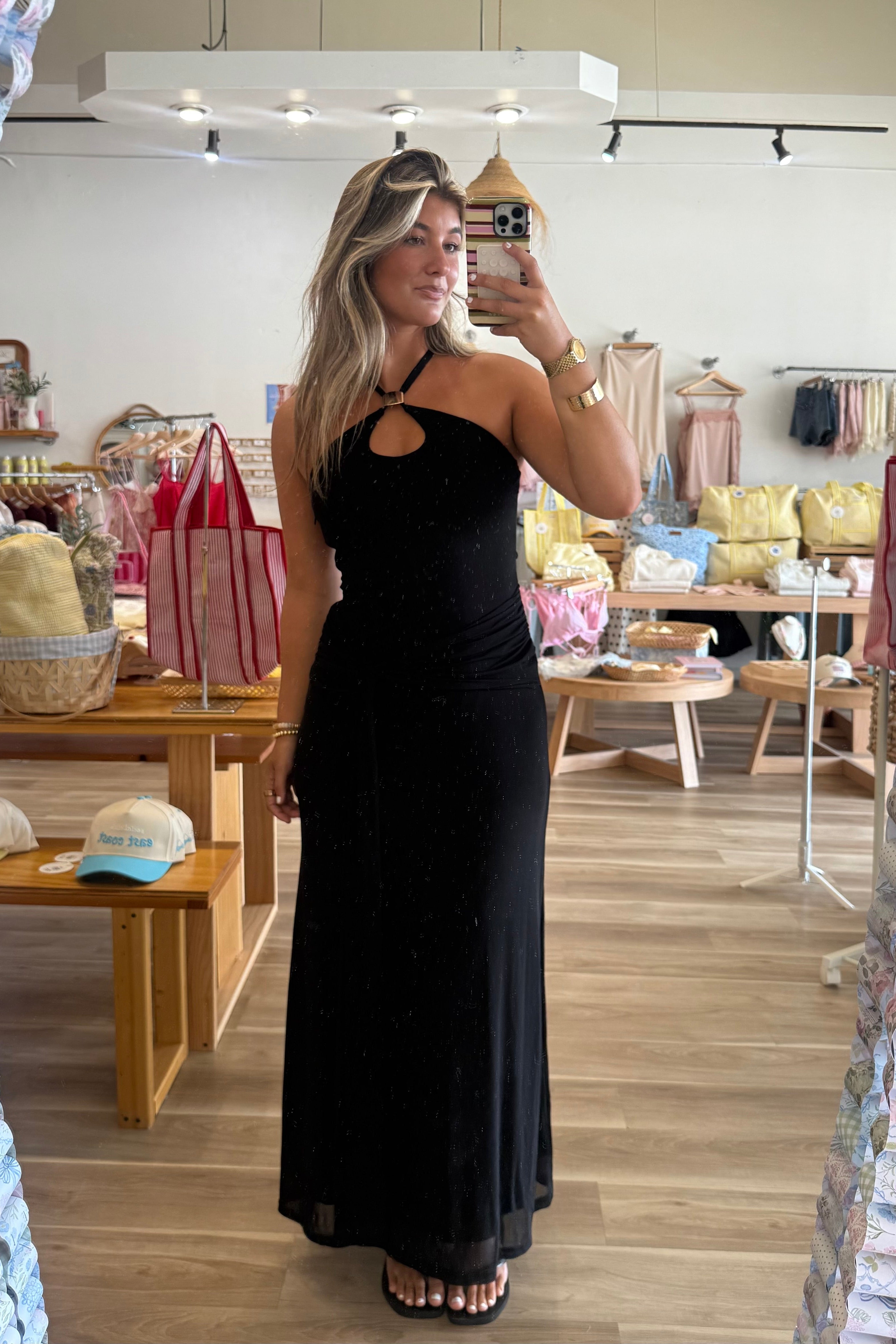Black, maxi dress with halter neckline, front cutout, fitted bodice, and draped scarf fabric