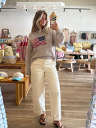 Cream, high-rise barrel jeans with curved leg and cuffed finish with buttons