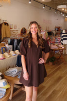 Brown, mini dress with V neckline, puff sleeves, pleated front, and A-line fit | Pixelated Boutique, Boutique Shopping in Virginia Beach, Women’s Boutique, Fall Fashion, Fall Dresses, Fall Shopping, Trendy Fall Outfits, Women’s Fall Clothing, Casual Fall Outfits