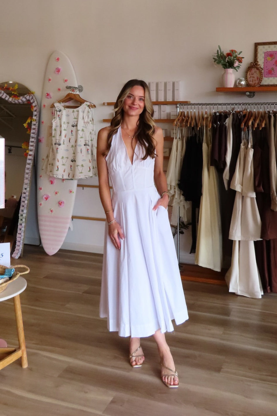 White, halter midi dress with V neckline, structured bodice, pleated skirt, and back zipper | Pixelated Boutique, Women's Clothing, Boutique Clothing for Women, Women’s Formal Dress, Women’s Occasion Dress, Maxi Dress, Wedding Guest Dress, Prom Dress, Graduation Party Dress 