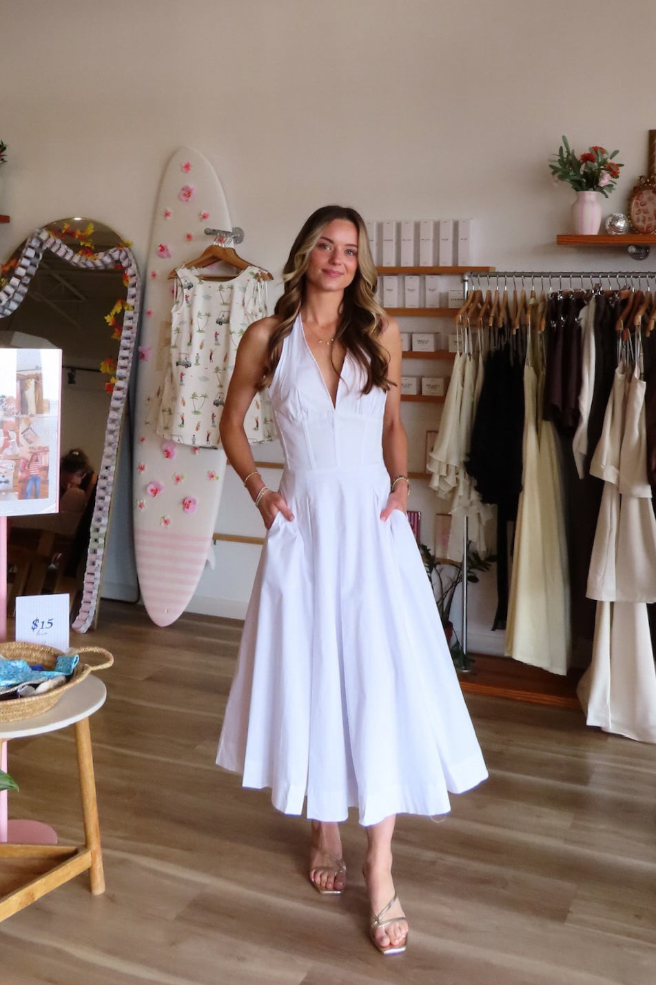 White, halter midi dress with V neckline, structured bodice, pleated skirt, and back zipper | Pixelated Boutique, Women's Clothing, Boutique Clothing for Women, Women’s Formal Dress, Women’s Occasion Dress, Maxi Dress, Wedding Guest Dress, Prom Dress, Graduation Party Dress 