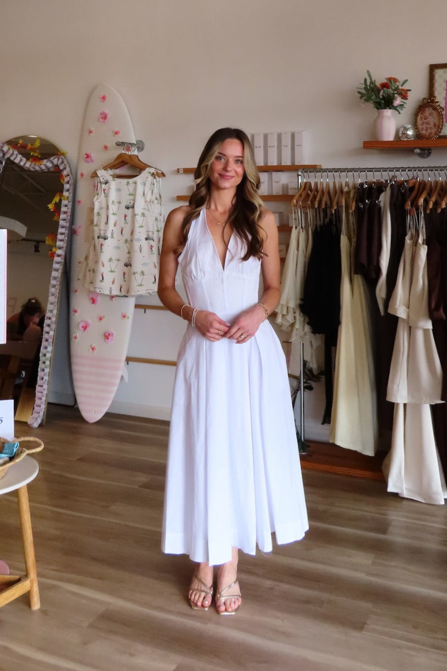 White, halter midi dress with V neckline, structured bodice, pleated skirt, and back zipper | Pixelated Boutique, Women's Clothing, Boutique Clothing for Women, Women’s Formal Dress, Women’s Occasion Dress, Maxi Dress, Wedding Guest Dress, Prom Dress, Graduation Party Dress 