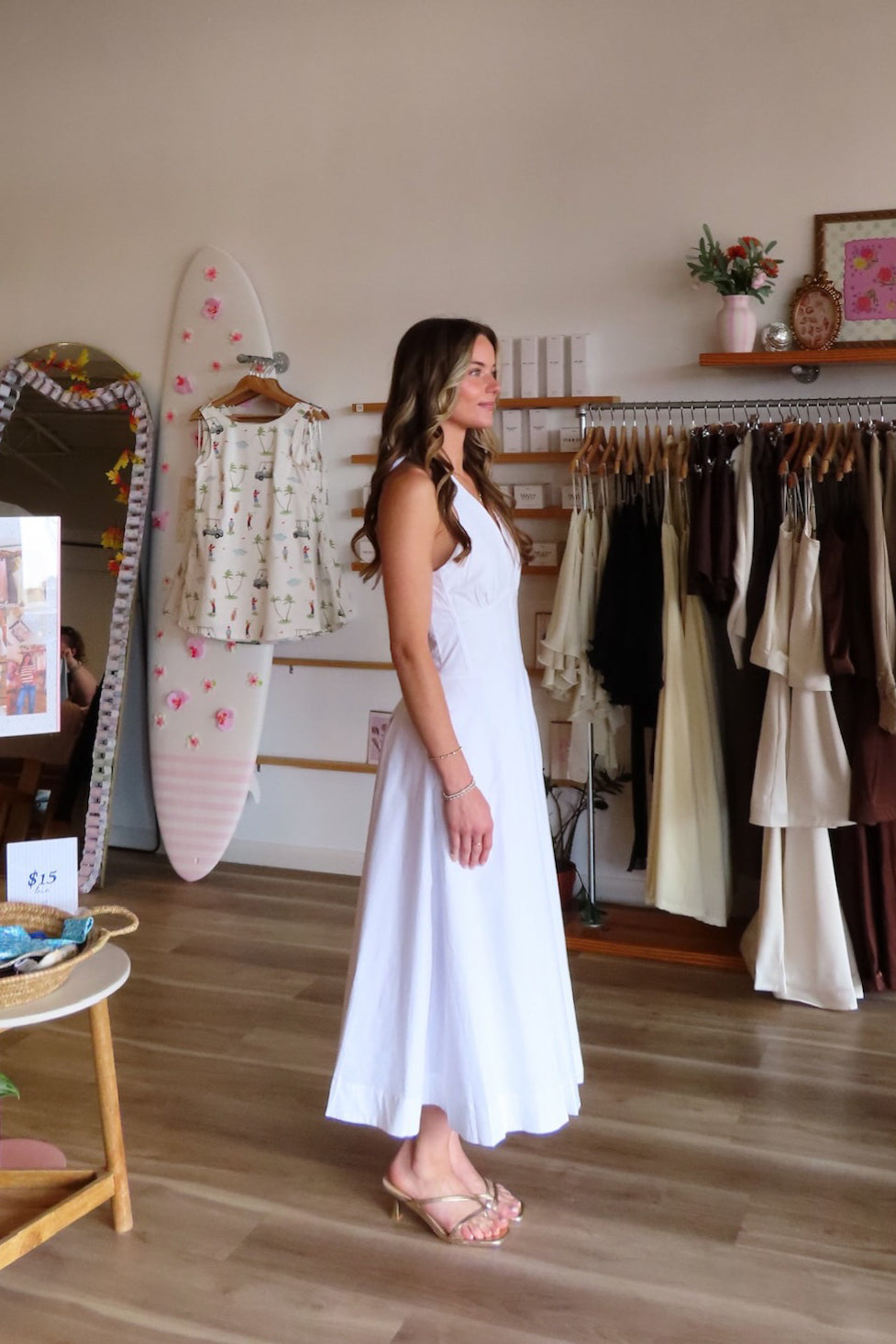 White, halter midi dress with V neckline, structured bodice, pleated skirt, and back zipper | Pixelated Boutique, Women's Clothing, Boutique Clothing for Women, Women’s Formal Dress, Women’s Occasion Dress, Maxi Dress, Wedding Guest Dress, Prom Dress, Graduation Party Dress 