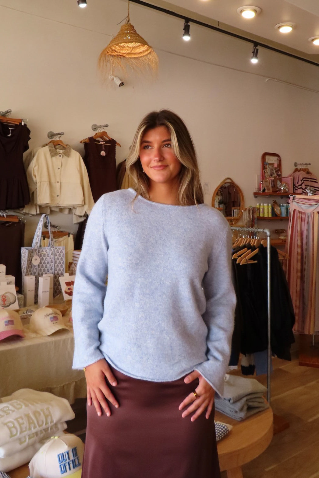 Blue, heathered knit top with round neckline, long sleeves, ruched sides, and raw hem | Pixelated Boutique, Boutique Clothing in Virginia Beach, Statement Sweaters, Chunky Sweaters, Trendy Sweaters, Cozy Knit Sweaters for Women, Oversized Sweaters, Cute Fall Sweaters, Fall Fashion Inspiration  