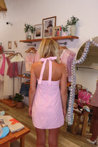Pink, gingham mini dress with halter neckline, tie neck, and back zipper, pink plaid mini dress, farmer's market dress, trendy casual dresses for summer, summer mini dress, vacation style, vacation outfits, beach boutique, beach fashion, beach outfits, coastal aesthetic clothing