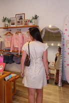 Cream, polka dot mini dress with V neckline, cap sleeves, and back tie, beach fashion, beach outfits, women’s boutique clothing, boutique clothing for women, coastal cowgirl outfits, coastal aesthetic clothing, business casual, concert outfit, 2000s fashion, western outfits