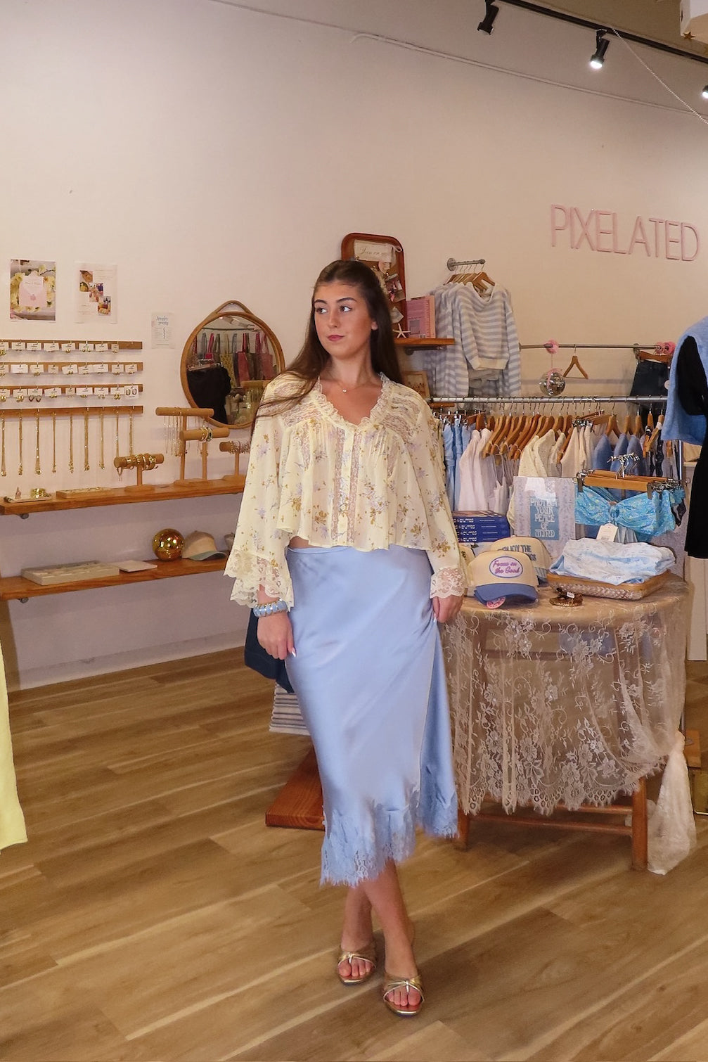 Blue, satin midi skirt with bias cut, lace hem, and side zipper, coastal cowgirl outfits, coastal aesthetic clothing, clean girl outfits, lace trim satin slip skirt, satin midi skirt, baby blue skirt for summer, low rise satin skirt, lace skirt for summer, happy hour outfit, summer satin skirt