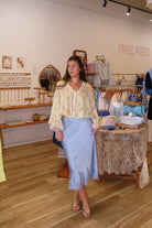 Blue, satin midi skirt with bias cut, lace hem, and side zipper, coastal cowgirl outfits, coastal aesthetic clothing, clean girl outfits, lace trim satin slip skirt, satin midi skirt, baby blue skirt for summer, low rise satin skirt, lace skirt for summer, happy hour outfit, summer satin skirt