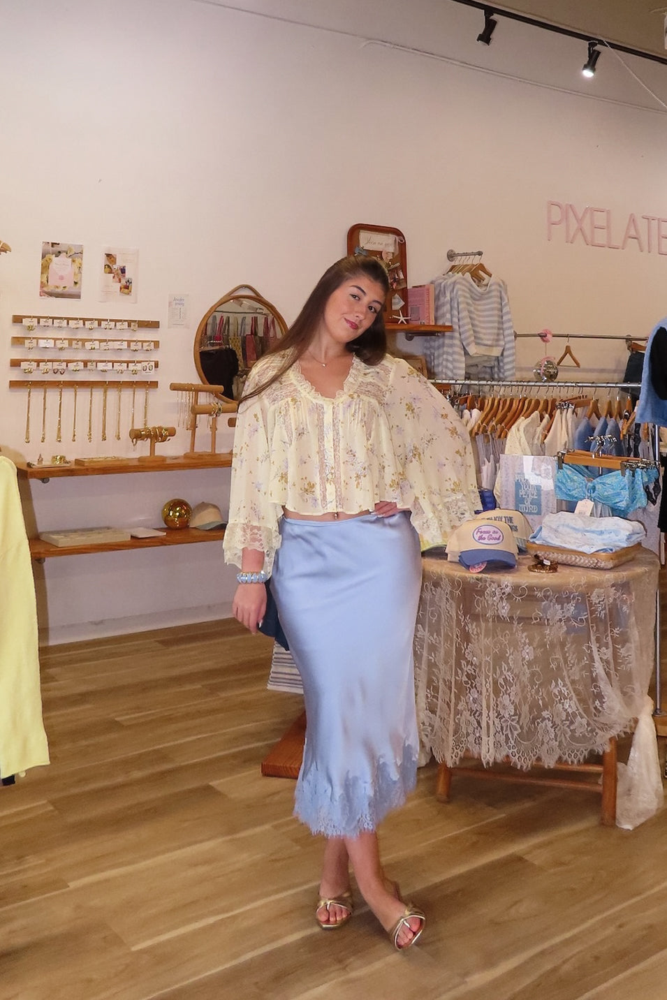 Blue, satin midi skirt with bias cut, lace hem, and side zipper, coastal cowgirl outfits, coastal aesthetic clothing, clean girl outfits, lace trim satin slip skirt, satin midi skirt, baby blue skirt for summer, low rise satin skirt, lace skirt for summer, happy hour outfit, summer satin skirt