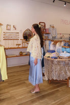 Blue, satin midi skirt with bias cut, lace hem, and side zipper, coastal cowgirl outfits, coastal aesthetic clothing, clean girl outfits, lace trim satin slip skirt, satin midi skirt, baby blue skirt for summer, low rise satin skirt, lace skirt for summer, happy hour outfit, summer satin skirt
