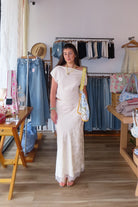 Cream, satin jacquard midi skirt with bias cut, lace trim, front bow, and side zipper