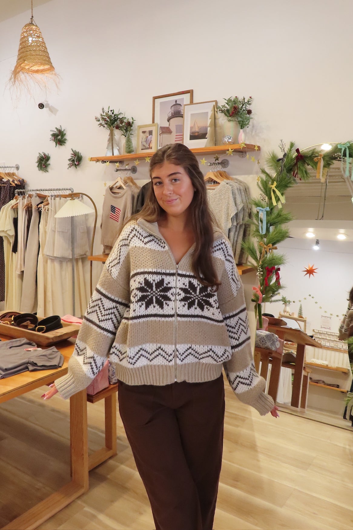Woman wearing a patterned sweater in a clothing store