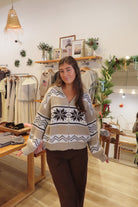 Woman wearing a patterned sweater in a clothing store