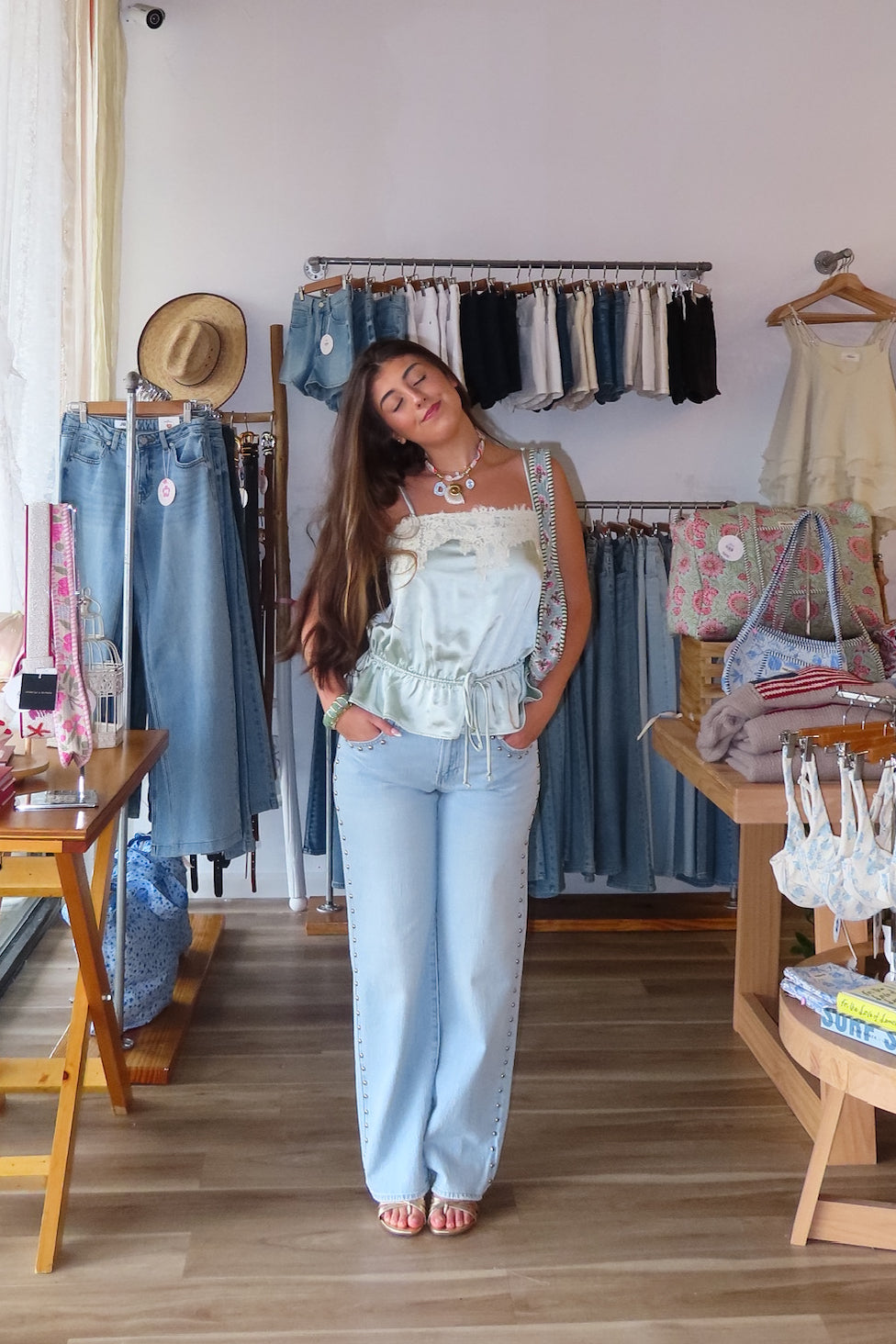 Blue, light wash jeans with low-rise, relaxed leg, and studded seams, studded jeans, vintage fit denim, summer denim, statement jeans for summer, low-rise jeans, low-rise light was denim, vacation outfits, beach outfits, coastal cowgirl, coastal aesthetic, beach girl fashion