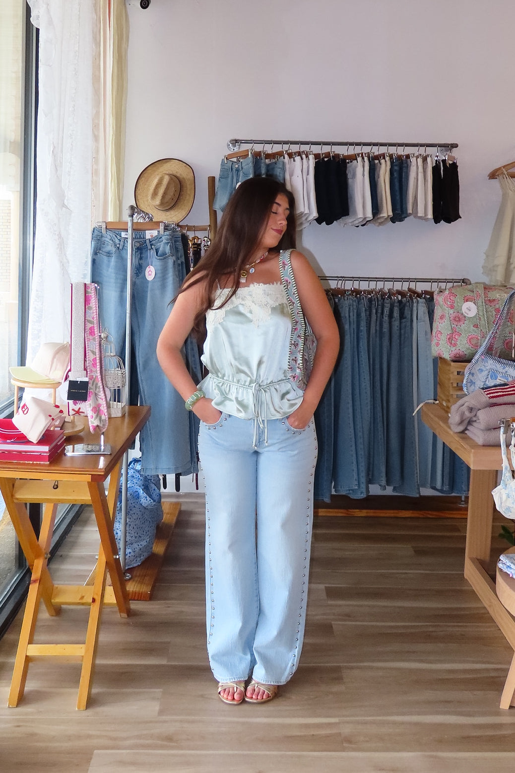 Blue, light wash jeans with low-rise, relaxed leg, and studded seams, studded jeans, vintage fit denim, summer denim, statement jeans for summer, low-rise jeans, low-rise light was denim, vacation outfits, beach outfits, coastal cowgirl, coastal aesthetic, beach girl fashion