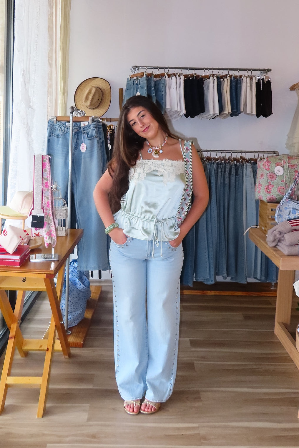 Blue, light wash jeans with low-rise, relaxed leg, and studded seams, studded jeans, vintage fit denim, summer denim, statement jeans for summer, low-rise jeans, low-rise light was denim, vacation outfits, beach outfits, coastal cowgirl, coastal aesthetic, beach girl fashion