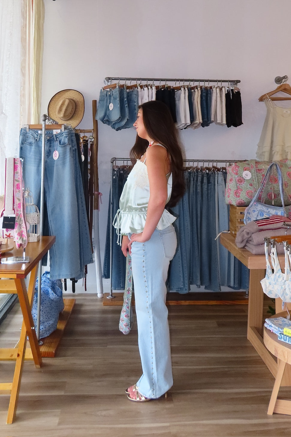 Blue, light wash jeans with low-rise, relaxed leg, and studded seams, studded jeans, vintage fit denim, summer denim, statement jeans for summer, low-rise jeans, low-rise light was denim, vacation outfits, beach outfits, coastal cowgirl, coastal aesthetic, beach girl fashion