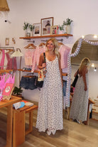Cream, polka dot maxi dress with V neckline, keyhole cutout with button, back tie, and cross straps, Pixelated Boutique, 757 Boutique, fashion, summer aesthetic, women’s trendy summer outfit, spring break, vacation style, vacation outfits, beach boutique, beach fashion, beach outfits, coastal aesthetic clothing, maxi dress, formal dress, wedding guest dress, satin slip dress, prom dress, graduation party dress