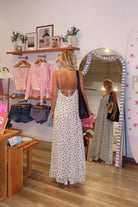 Cream, polka dot maxi dress with V neckline, keyhole cutout with button, back tie, and cross straps, Pixelated Boutique, 757 Boutique, fashion, summer aesthetic, women’s trendy summer outfit, spring break, vacation style, vacation outfits, beach boutique, beach fashion, beach outfits, coastal aesthetic clothing, maxi dress, formal dress, wedding guest dress, satin slip dress, prom dress, graduation party dress