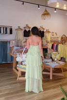 Light green, maxi dress with halter neckline, ruffled tiers, and asymmetric hem, summer maxi dress, formal dress, wedding guest dress, high low maxi dress, prom dress, graduation dress, mermaid core aesthetic, sage green ruffled maxi dress, pastel formal maxi dress 