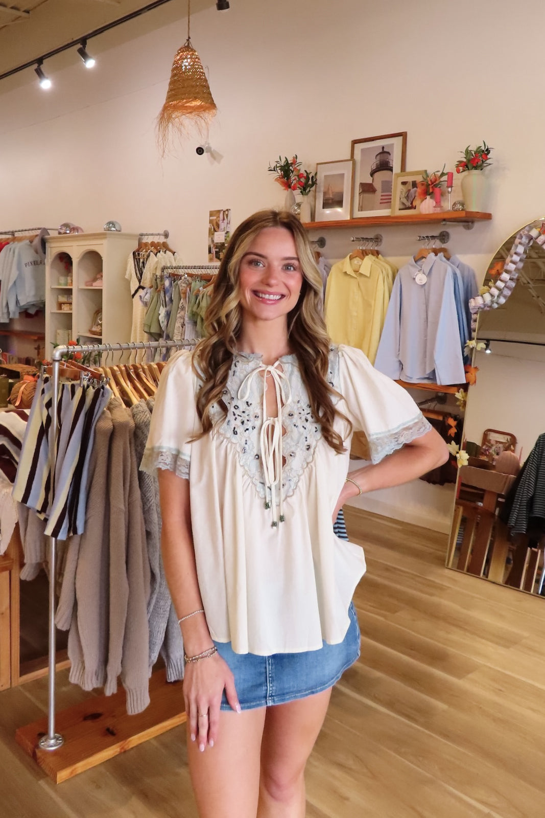 Cream, bohemian blouse with high V neckline, beaded front ties, puff sleeves, and lace trim