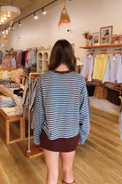 Blue and brown, striped top with long sleeves, drop shoulder, and oversized fit