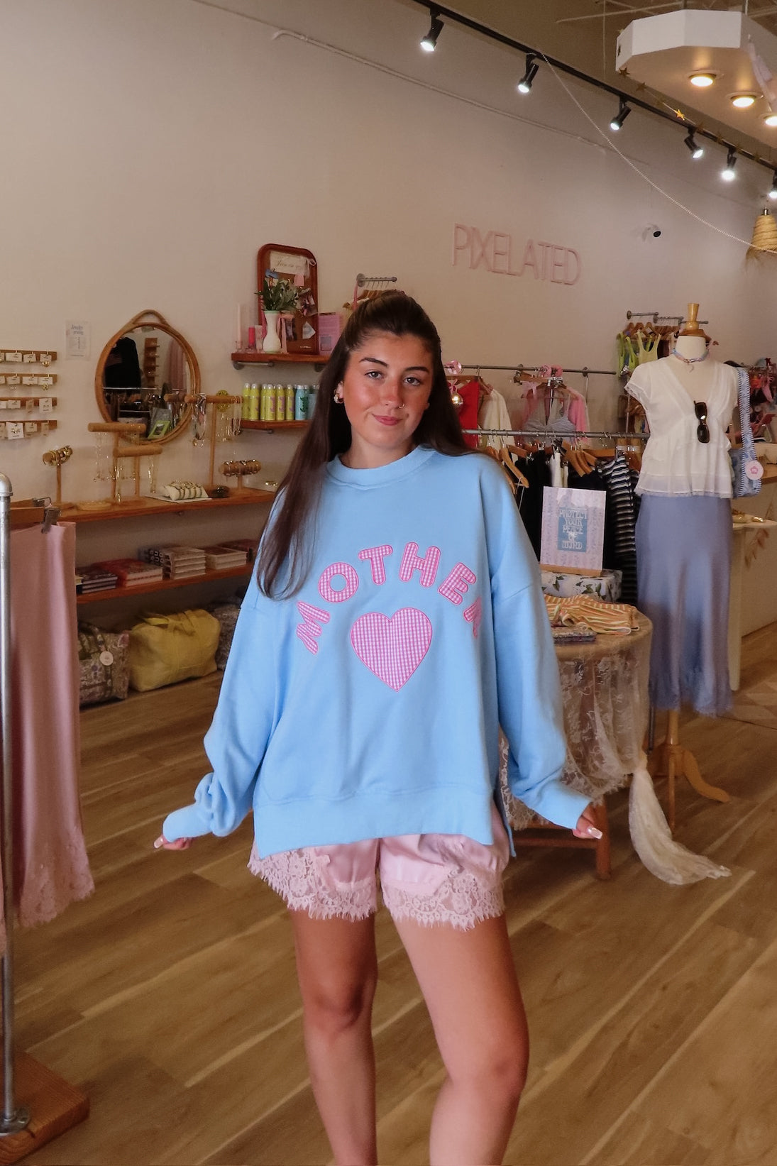 Blue, gingham heart and “MOTHER” embroidered in pink sweatshirt with crew neckline and fleece lining. Oversized and slightly cropped.

By The Beach Club