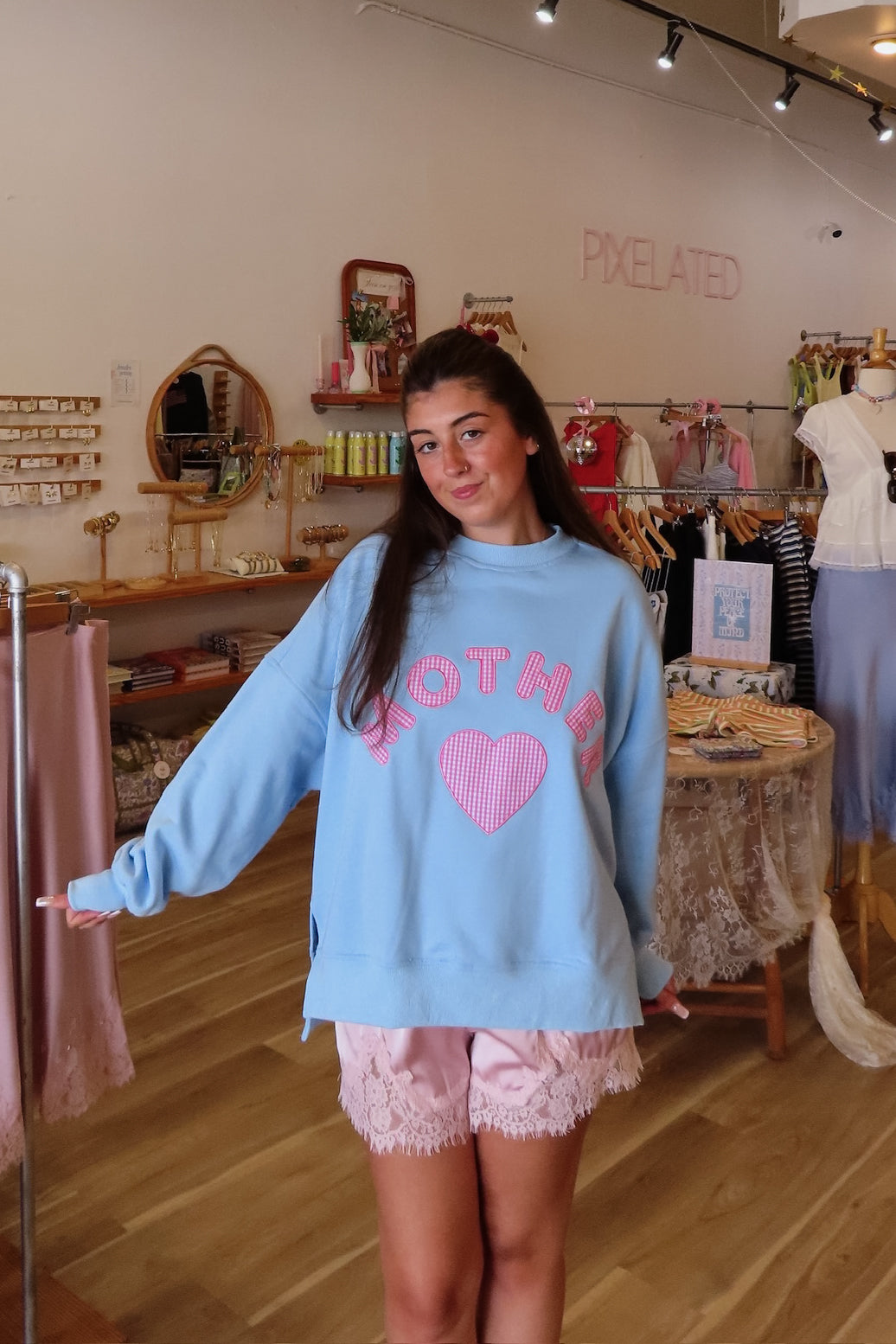 Blue, gingham heart and “MOTHER” embroidered in pink sweatshirt with crew neckline and fleece lining. Oversized and slightly cropped.

By The Beach Club