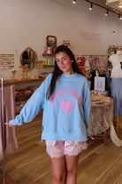 Blue, gingham heart and “MOTHER” embroidered in pink sweatshirt with crew neckline and fleece lining. Oversized and slightly cropped.

By The Beach Club