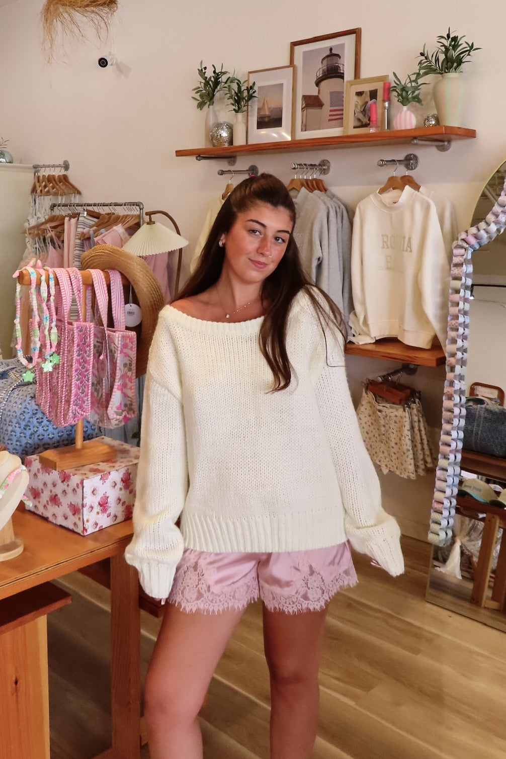 Cream, knit slightly oversized sweater with off-shoulder boat neckline and ribbed hem