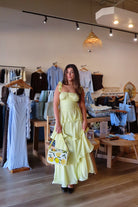 Pixelated Boutique, Women's Clothing, Online Shopping for Women, Fashion Trends 2026, Outfit Inspo, Virginia beach clothing stores, clothing stores in Virginia Beach, fashion outfits, fashion Inspo, women’s outfit 2026, outfit ideas, fashion, spring aesthetic, women’s spring outfit, spring style, spring break, maxi dress, yellow tiered dress, wedding guest dress 