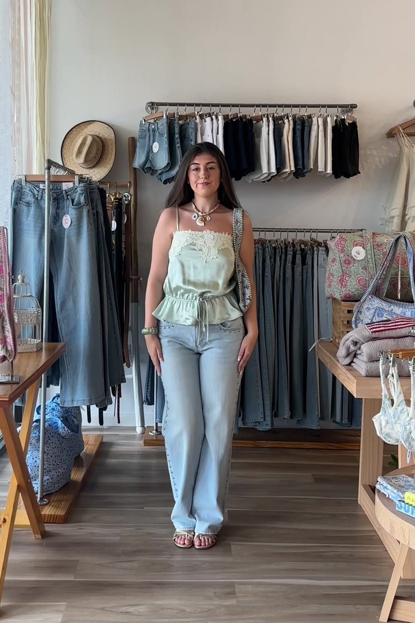 Blue, light wash jeans with low-rise, relaxed leg, and studded seams, studded jeans, vintage fit denim, summer denim, statement jeans for summer, low-rise jeans, low-rise light was denim, vacation outfits, beach outfits, coastal cowgirl, coastal aesthetic, beach girl fashion