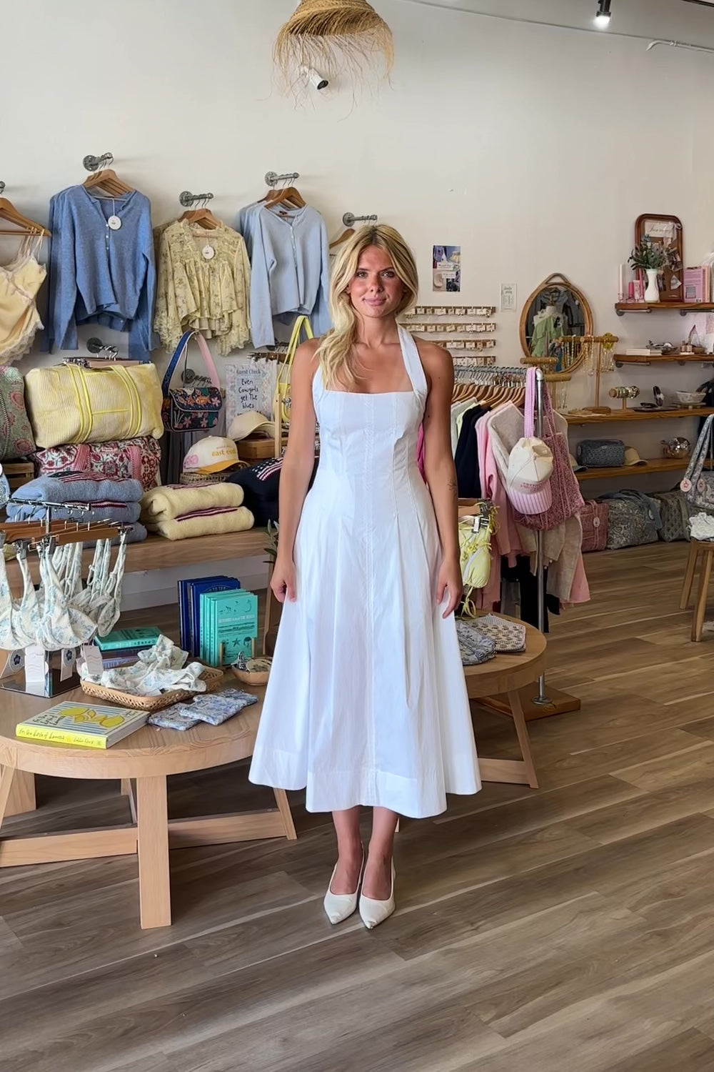 White, halter midi dress with square neckline, structured bodice, flared skirt, and side pockets | Pixelated Boutique, Virginia Beach Boutique, white maxi dress, white lace dress, boho maxi dress, bridal shower dress, bachelorette dress, graduation dress